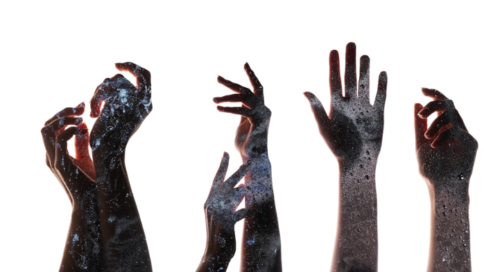 Expressive raised hands representing women’s rights in WWII Asia, highlighting Korea comfort women issue, historical narratives, and scholarly debate.